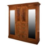 Early 20th Century mahogany and string inlaid three section wardrobe, the central pair of doors