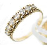 Two 9ct gold wedding bands, a diamond set dress ring, the shank stamped '18ct' and one other dress