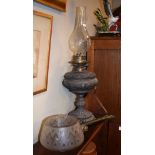 Late 19th/early 20th Century cast metal oil lamp, together with an adjustable wall mounting gas lamp