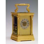Large satin brass cased repeat carriage clock, the silvered dial with Arabic numerals and set within