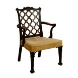 George III mahogany open arm elbow chair having a carved serpentine crest rail, pierced trellis