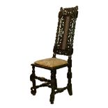 17th Century heavily carved walnut high back side chair, pierced and carved crest rail with
