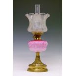 Victorian oil lamp, the pink glass shade having embossed stylised foliate decoration, flared brass