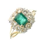 Emerald and diamond cluster ring, unmarked, the step cut measuring approximately 5.4mm x 3mm deep,