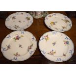 Four Sevres style plates, each painted with foliate sprays within a moulded blue painted border,