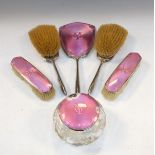 George V silver and pink enamel five piece brush set with matching cut glass powder bowl, each piece