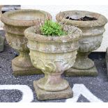 Set of three 'stone' urn shaped garden planters Condition: