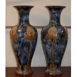 Pair of Doulton Lambeth slender baluster shaped vases, each having Art Nouveau design stylised