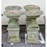 Set of four 'stone' classical design urns with pedestals Condition: