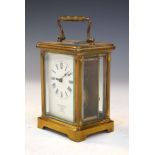 French brass cased carriage clock, the off-white dial with Arabic numerals, with outer carrying case