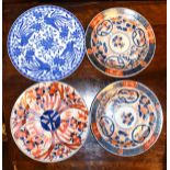 Four Oriental blue and white and iron-red decorated plates Condition: