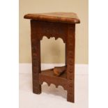 Late 19th Century oak triangular stool, the carved frieze and legs with text 'Israel' and the