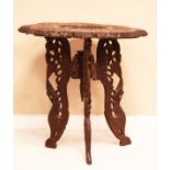 Oriental carved shaped circular top occasional table, raised on three carved monopodia supports