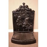Cast iron fire back depicting two figures with cherub cresting, together with a fire basket and