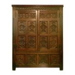 Antique oak two door cupboard having a moulded cornice, carved arcaded frieze below, the panel doors