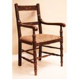 Early 20th Century carved oak bar back open arm elbow chair, standing on bobbin turned supports