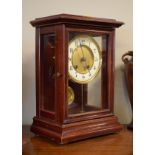 Early 20th Century stained beech cased mantel clock, the gilt dial having an off-white chapter
