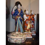 Three Oriental porcelain enamel decorated figures of females, together with a circular pot and cover