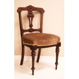 Set of four Victorian walnut dining chairs having carved pierced splats, stuff over seats and turned