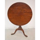 George III mahogany circular snap top supper table with birdcage fitting, on turned column and