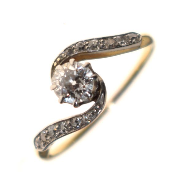 Diamond set crossover dress ring, the shoulders having diamond points, size L Condition: