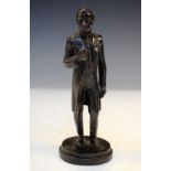 Early 20th Century patinated bronze figure of a dapper gentleman in frockcoat, the circular plinth