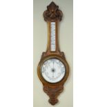 Early 20th Century carved oak cased aneroid barometer and thermometer Condition: