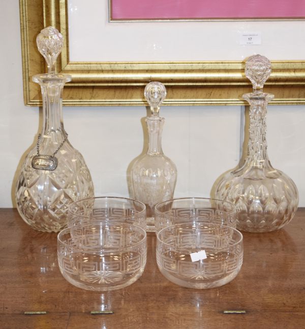 Three cut glass decanters and four cut glass finger bowls having Greek key decoration Condition: