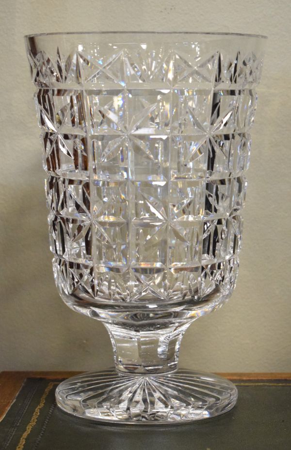 Waterford heavy cut crystal vase having a bucket bowl and standing on a circular star cut foot