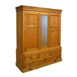 Late 20th Century pine wardrobe fitted two drawers flanking a central mirror panel, the base