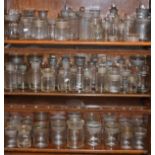 Large quantity of clear glass apothecary jars (three shelves) Condition: