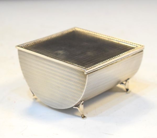 George V silver trough shaped desk top cigarette box having engine turned decoration and hinged