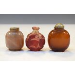 Chinese carved ruby and clear overlaid snuff bottle having foliate and animal decoration, a