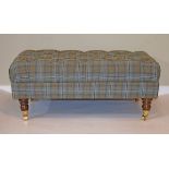 Reproduction rectangular top footstool having a stuffed seat and standing on turned supports with