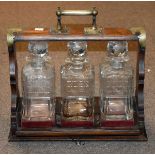 Early 20th Century silver plated mounted oak tantalus fitted three cut glass decanters Condition: