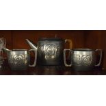 Roundhead pewter three piece tea service having Arts & Crafts design embossed and hammered