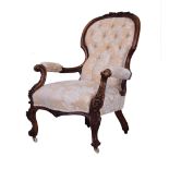 Victorian gentleman's carved walnut framed open arm drawing room chair upholstered in floral