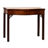 George III mahogany serpentine front fold over supper table standing on four square moulded supports