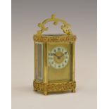 Early 20th Century French brass Louis XV Doucine cased carriage clock, the dial with off-white