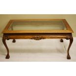 Large reproduction rectangular glass top coffee table standing on carved cabriole ball and claw