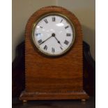 Early 20th Century inlaid oak arch shaped mantel clock, the white enamel dial with Roman numerals