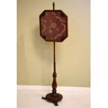 Early 19th Century mahogany pole screen having triple scroll supports Condition: