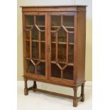 1920's period oak cabinet bookcase fitted four shelves enclosed by a pair of glazed doors and