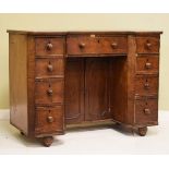 Victorian mahogany breakfront kneehole desk fitted nine drawers, a cupboard to the kneehole and