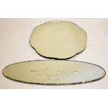 Oval bevelled frameless wall mirror with reverse cut decoration together with another frameless wall