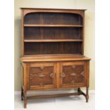 1920's period oak dresser, the upper fitted two shelves, the base fitted two cupboard doors