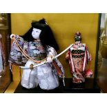 Two modern Japanese dolls contained in a display case Condition: