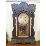 Late 19th/early 20th Century stained beech 'Gingerbread' style cased mantel clock Condition: