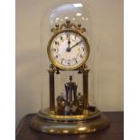 Brass anniversary clock beneath a glass dome Condition: