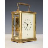 Modern brass cased carriage clock, the off-white dial with Roman numerals and retailers mark for